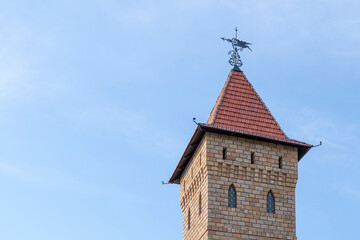 Fototapeta na wymiar the tower of an old castle with a weather vane
