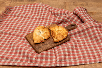 Typical Argentine recipe of meat patties with sesame and poppy seeds on a table