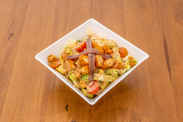 Cesar salad with breaded chicken, sauce, sliced cheese, cherry tomatoes and anchovies