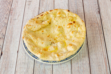 Hindu cheese naan recipe served in a pakistani restaurant in europe on white background