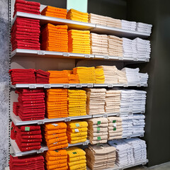 Colorful towels on shelf for sale 