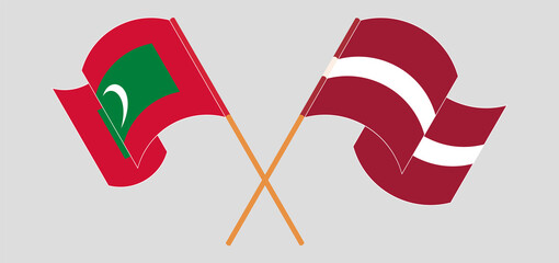 Crossed and waving flags of Maldives and Latvia