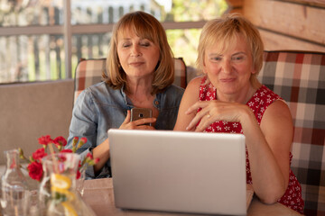 Mature woman received phone call and pressed the phone to her heart, her friend is happy for her