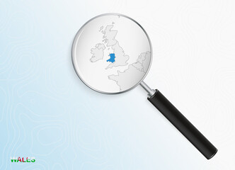 Magnifier with map of Wales on abstract topographic background.