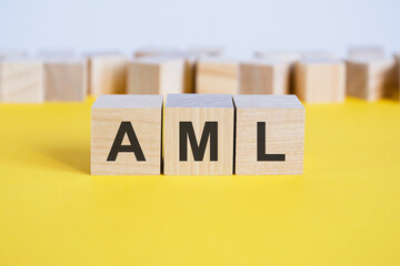 aml letters on wooden building blocks lying on the yellow table, concept