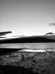 Playa con montañas y oceano blanco y negro
