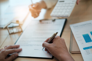 After a discussion in a exclusive room at the corporate , a businessman and his partner sign a contract investment professional paper agreement.