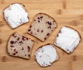 sliced bread with cranberryies on wooden table