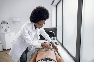 Medicine, health and heart check-up concept. Young afro-american woman doctor with...