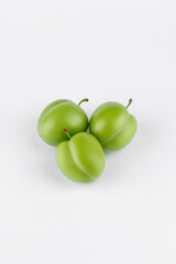 fresh and green plum on white background