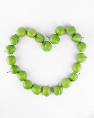fresh and green plum on white background