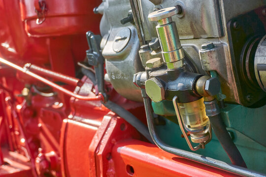 Closeup Of Fuel Filter With Transparent Under Cup On Old Red Restored Tractor. Image With Selective Focus.   