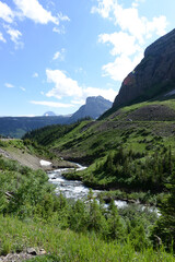 Naklejka na ściany i meble River flowing through Glacier National Park