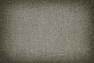 Natural canvas, sackcloth, dark grey color. Close-up of jute texture pattern with vignette, vintage background