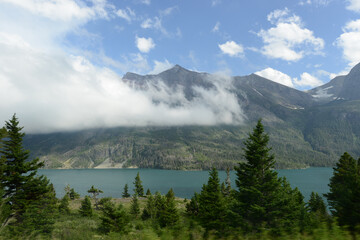 Scenic view of mountains, trees and a lake at Glacier National Park in Montana
