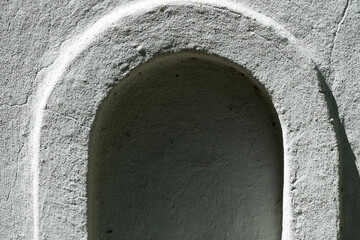 old stone arch or stucco drinking fountain niche