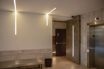Building lobby with recessed LED light strips on walls and ceilings, nobody