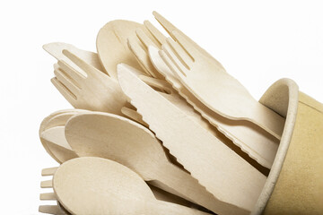 Wooden cutlery in a paper cup. Disposable accessories used in fast food restaurants.