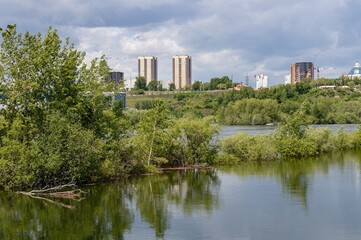 Fototapeta na wymiar View from the side of Tatyshev Island to the high-rise residenti