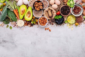 Ingredients for the healthy foods selection. The concept of superfoods set up on white shabby concrete background with copy space. - obrazy, fototapety, plakaty
