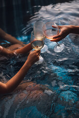 Women with wine glasses in hot tub