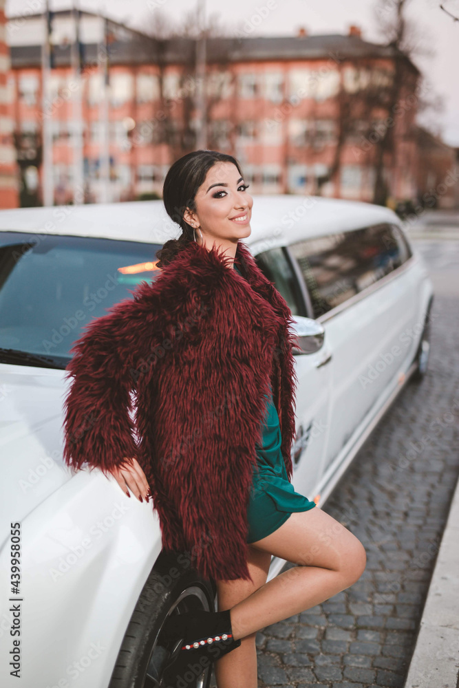 Canvas Prints Vertical shot of a white Caucasian woman wearing a red furry jacket and posing for a picture