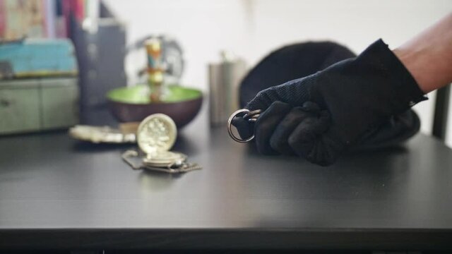 Girl with black gloves picks up Keys and passing by