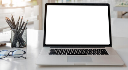 Blank screen Laptop computer and poster workspace background in modern office