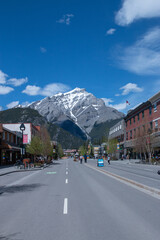 Banff village street with mountain in background COVID-19 sign