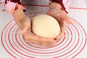 Close Up Asian Female Hand Rounding Raw Bread Dough, Baking Process Making Japanese Fluffy White...