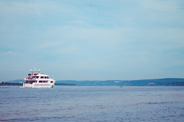 Boat at sea. The white ship sails along the river.