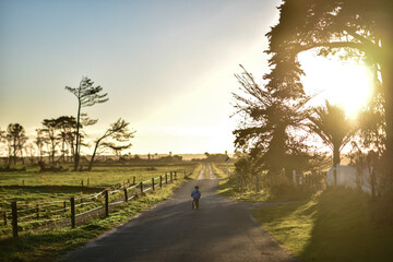 Kids running to Sunset Karamea Estuary, New Zealand