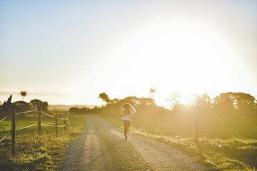 Girl running to Sunset Karamea Estuary, New Zealand