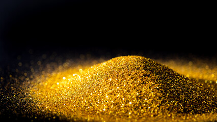 Fototapeta na wymiar Elegant and precious sparkling golden powder pile on black background.