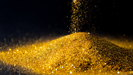 Sprinkle glittering gold powder elegant and precious on a black background