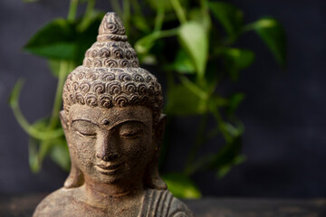  Statuette of Buddha on a dark background copy space for text