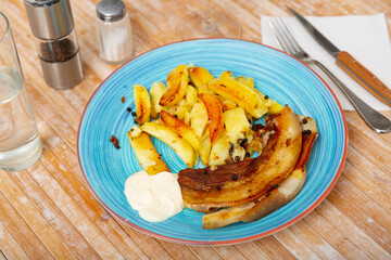 Image of fried pork bacon on a plate and French fries...