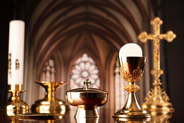 First Holy Communion. Catholic religion theme. Crucifix, the Cross and Golden chalice and wafer on...
