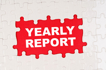 In the middle of the puzzles on a red background it is written - YEARLY REPORT