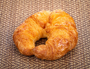 Delicious breakfast with fresh croissants on wooden background