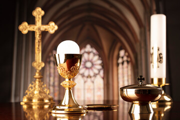 First Holy Communion. Catholic religion theme. Crucifix, the Cross and Golden chalice and wafer on...