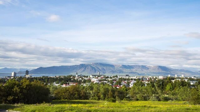 Time Lapse of Reykjavik from above viewed from Perlan with mountain in the background and clouds passing by