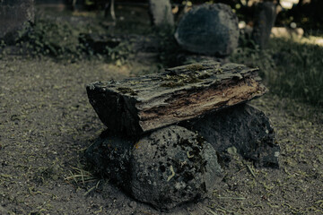 old wooden bench and gravestone in abandoned latvian cemetery