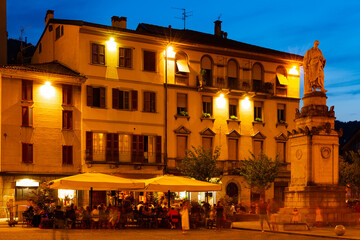 Busy nightlife of illuminated central Como streets in summer, Italy..