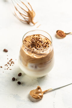Dalgona coffee. Iced fluffy creamy whipped trend drink. Korean coffee drink instant coffee. vertical image. top view