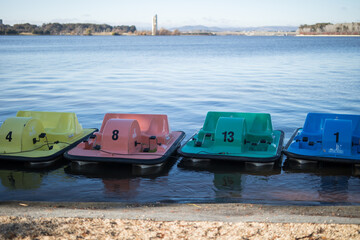 Row colorful paddle boats ladke water fun summer holiday pink green blue yellow 