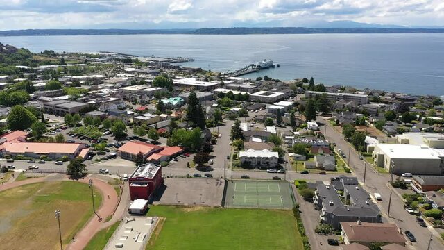 Cinematic 4K drone footage of the downtown Edmonds commercial area, Kingston ferry terminal waterfront marina, near Seattle in Western Washington, Pacific Northwest, in Snohomish County