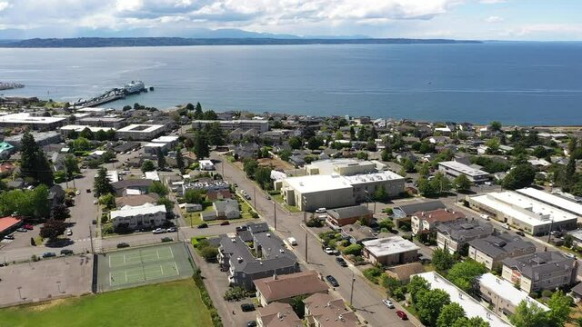 Cinematic 4K drone panning footage of the downtown Edmonds commercial area, Kingston ferry terminal waterfront marina, near Seattle in Western Washington, Pacific Northwest, in Snohomish County