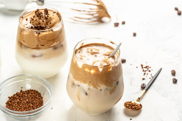 Homemade Dalgona coffee in glass cup with ingredients, Trendy drink latte with foam of instant coffee