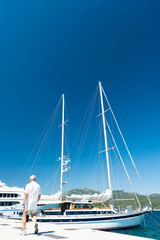Stunning view of a sailboat moored to a port during a sunny day. Porto Rotondo, Sardinia, Italy.